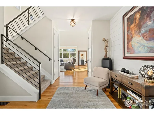 a living room with furniture and a painting on the wall