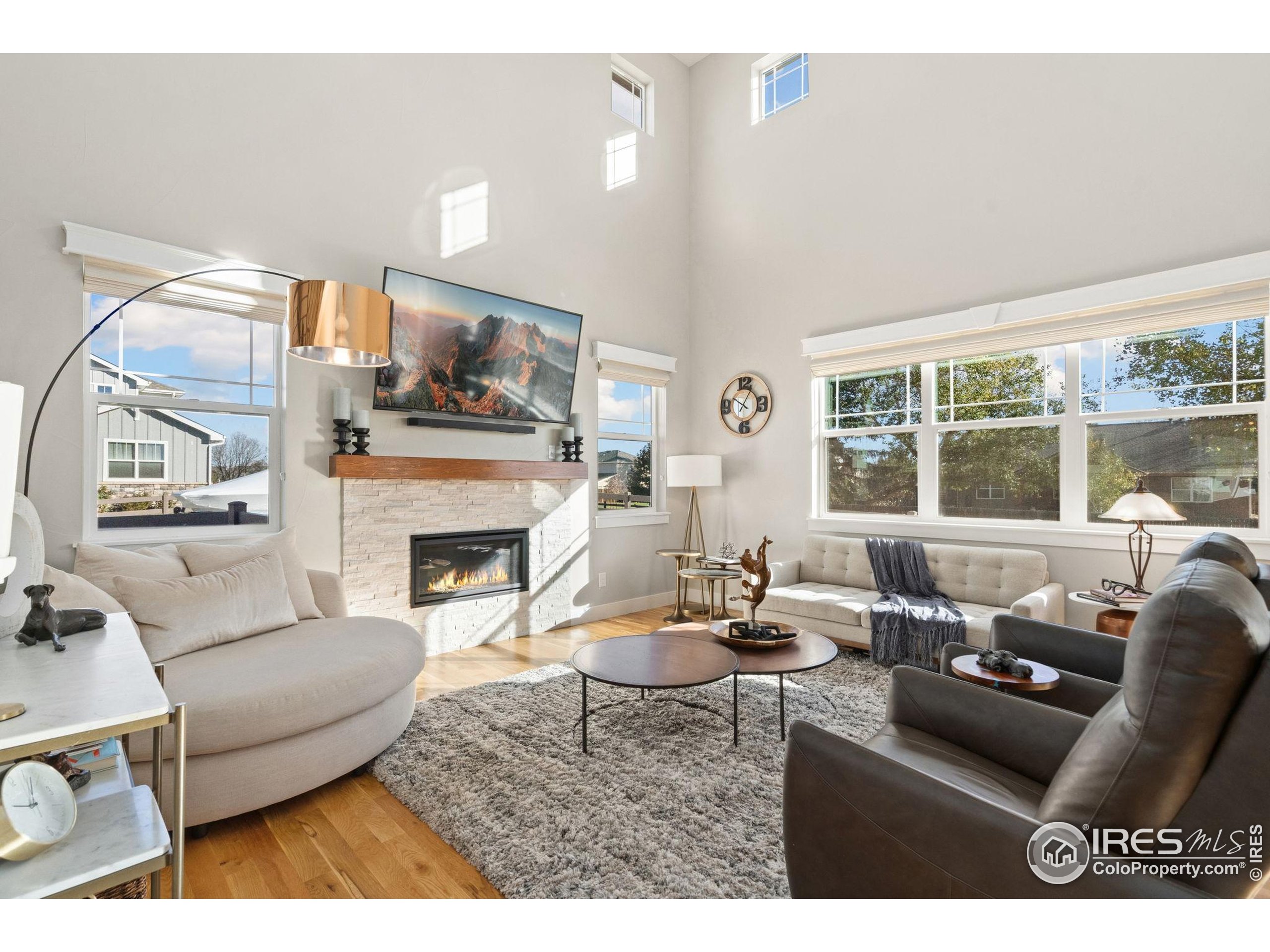 2032 Cuda Court Berthoud, CO 80513 - Photo 7 of 38 a living room with furniture a fireplace and a large window