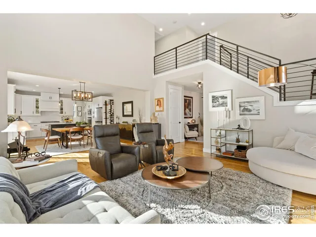 a living room with furniture a rug and white walls