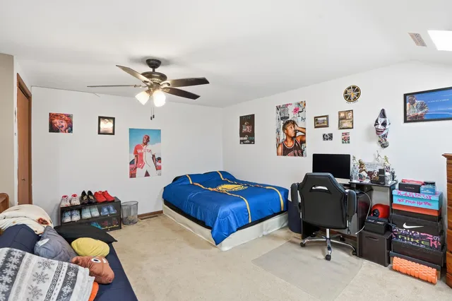 a workspace with furniture and ceiling fan