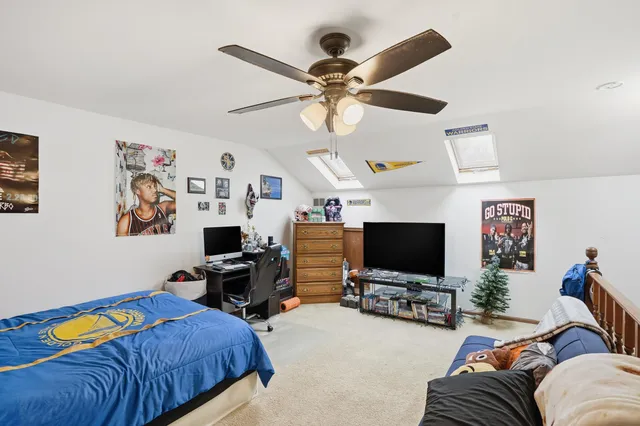 a bedroom with furniture and a flat screen tv
