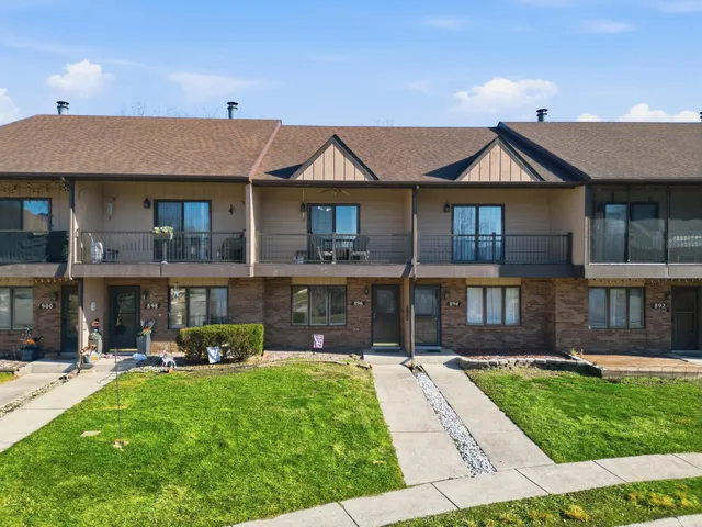 a front view of a house with a yard table and chairs