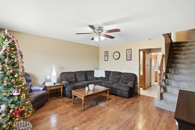 a living room with furniture and a potted plant