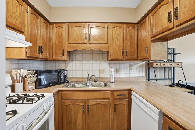 a kitchen with a sink cabinets and appliances
