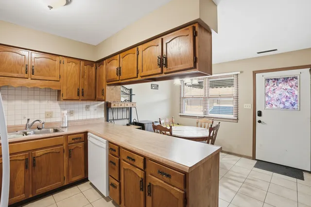 a kitchen with a sink cabinets and window