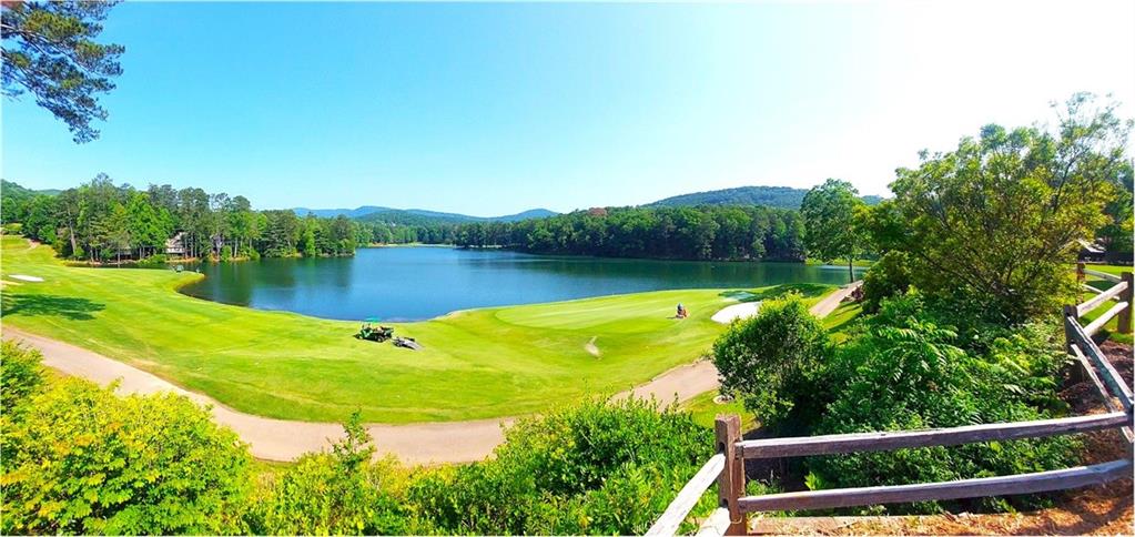 26 Chestnut Oak Point Jasper, GA 30143 - Photo 13 of 32 a view of a lake with a house in the background