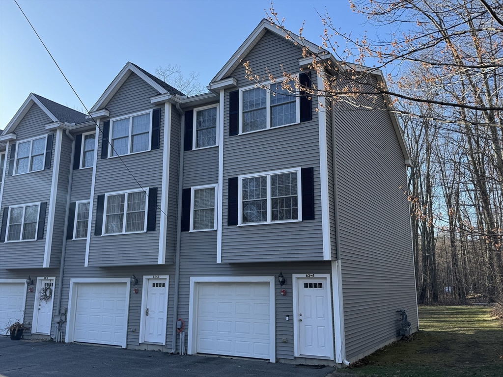 63 Shrine Avenue, Unit 4 West Boylston, MA 01583 - Photo 1 of 1 a front view of a house with a yard
