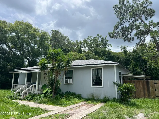 a front view of house with yard and trees