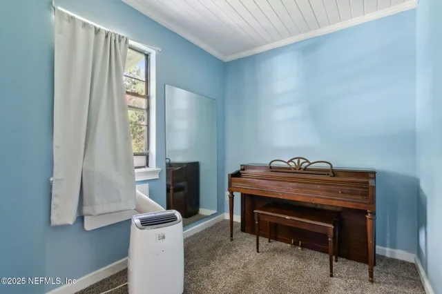 a room with a piano and a window