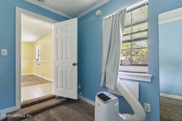 a view of front door and bedroom