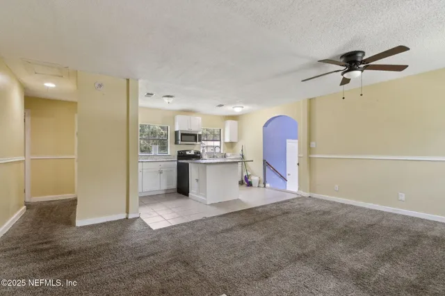 a view of a kitchen with furniture and a fan