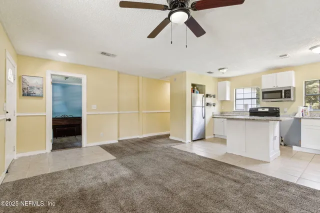 a view of a kitchen with electric appliances