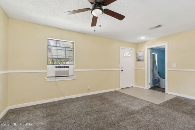 a view of an empty room with a window