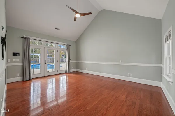 a view of empty room with a fireplace and fan