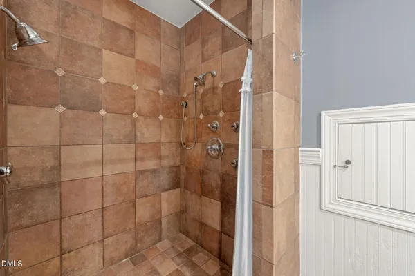 a view of empty room with wooden floor and window