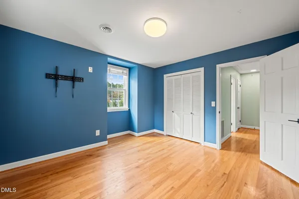 a view of a backyard with wooden fence and large trees