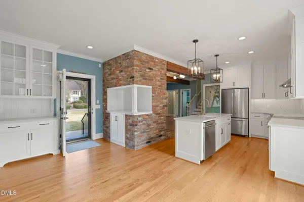 a kitchen with stainless steel appliances granite countertop a stove and cabinets