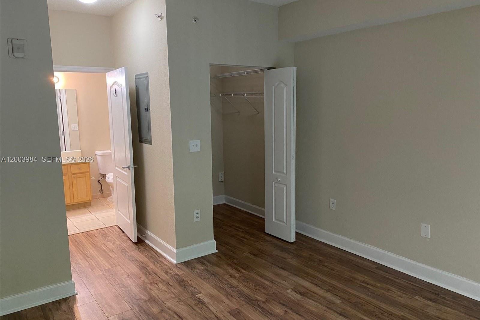 6001 Southwest 70th Street, Unit 342 South Miami, FL 33143 - Photo 13 of 19 a view of a room with wooden floor and a bathroom