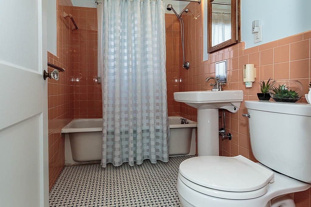 29 Ware Road Newton, MA 02466 - Photo 12 of 25 a white toilet sitting next to a bathroom sink