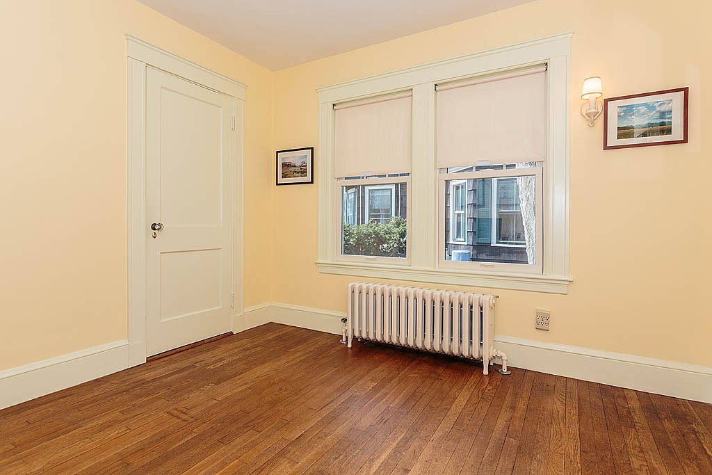 29 Ware Road Newton, MA 02466 - Photo 15 of 25 an empty room with wooden floor and windows