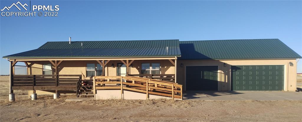 an outdoor view of patio with table and chairs