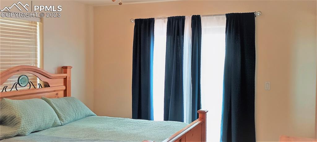 1260 County Road South Rush, CO 80833 - Photo 12 of 41 a bedroom with a bed and a window