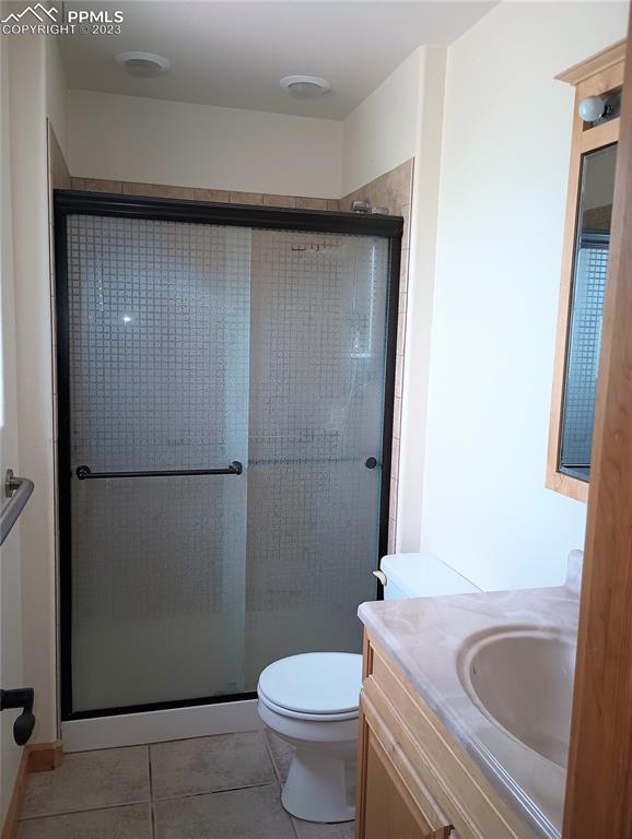 1260 County Road South Rush, CO 80833 - Photo 13 of 41 a bathroom with a granite countertop sink toilet and shower