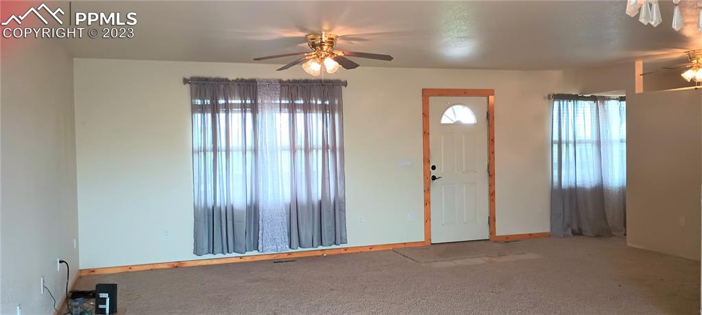 1260 County Road South Rush, CO 80833 - Photo 2 of 41 a view of a hallway with windows and chandelier