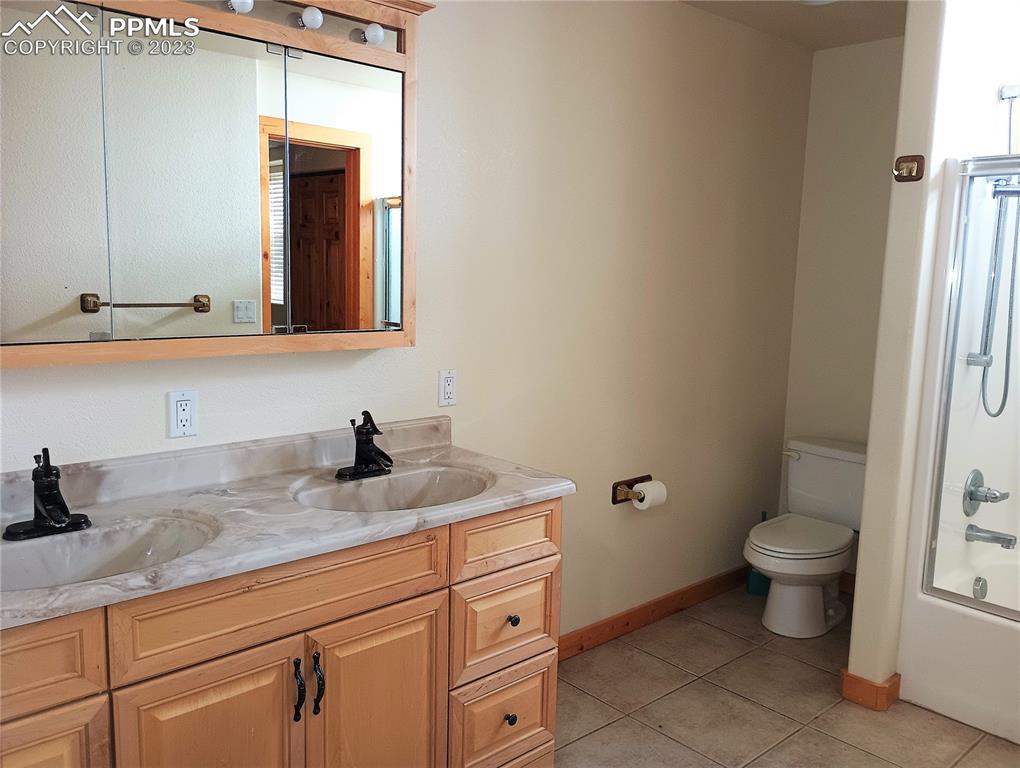 1260 County Road South Rush, CO 80833 - Photo 21 of 41 a bathroom with a granite countertop toilet sink and mirror