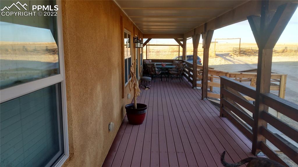 1260 County Road South Rush, CO 80833 - Photo 25 of 41 a view of a balcony with chairs and wooden floor