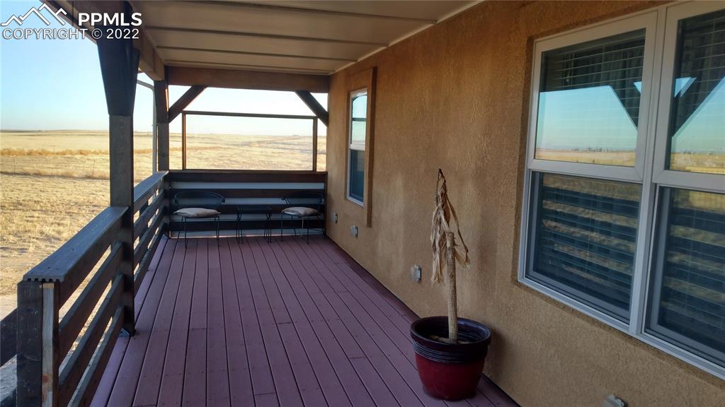 1260 County Road South Rush, CO 80833 - Photo 26 of 41 a view of a balcony with furniture and wooden floor