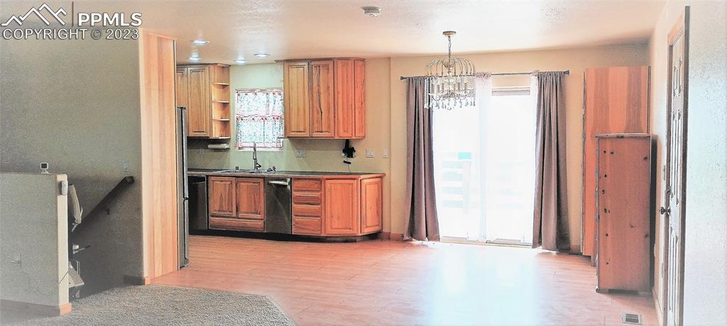 1260 County Road South Rush, CO 80833 - Photo 3 of 41 a kitchen with stainless steel appliances a refrigerator sink and cabinets