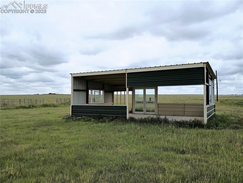 1260 County Road South Rush, CO 80833 - Photo 38 of 41 a backyard of a house with lots of green space and garden