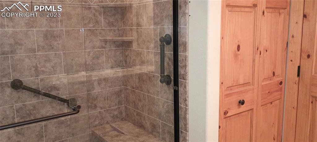 1260 County Road South Rush, CO 80833 - Photo 9 of 41 a bathroom with a glass shower door