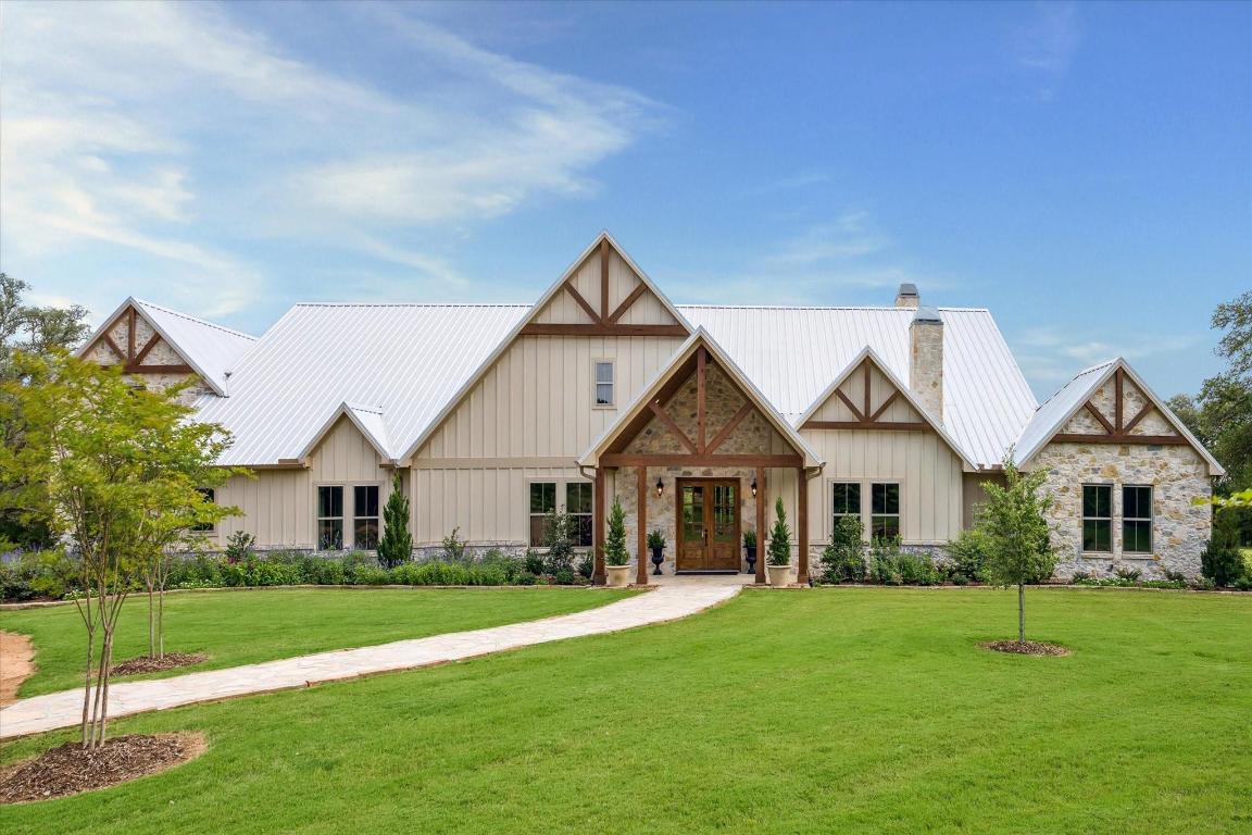 a front view of a house with a garden and yard