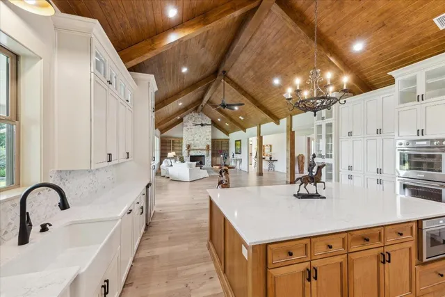 a kitchen with stainless steel appliances a sink a counter top space cabinets and wooden floor