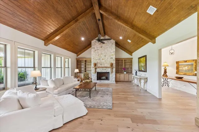 a living room with furniture a fireplace and a table