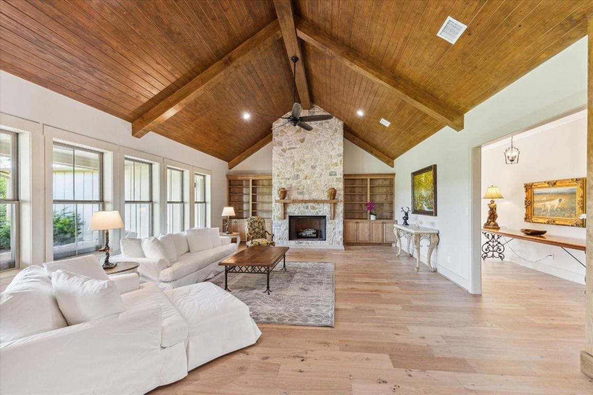 2130 Hartfield Road Round Top, TX 78954 - Photo 13 of 39 a living room with furniture a fireplace and a table