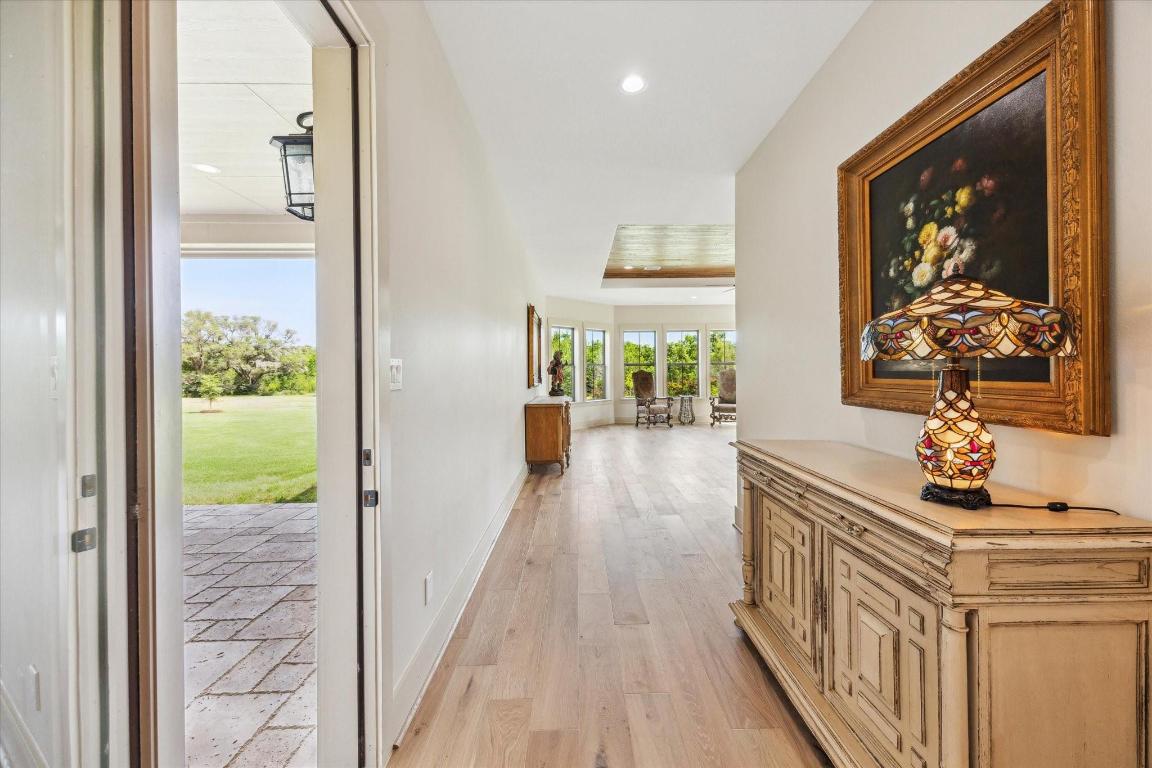 2130 Hartfield Road Round Top, TX 78954 - Photo 19 of 39 a view of a hallway with wooden floor and windows