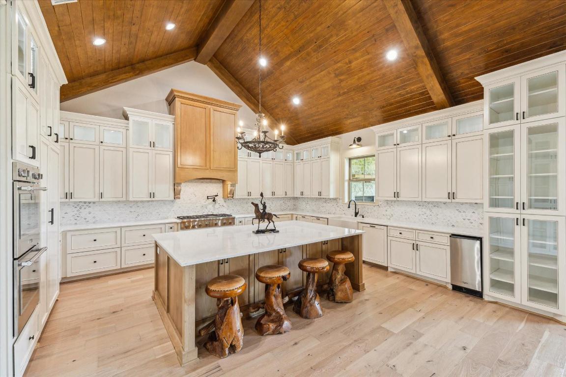 2130 Hartfield Road Round Top, TX 78954 - Photo 2 of 39 a large white kitchen with cabinets a sink and stainless steel appliances