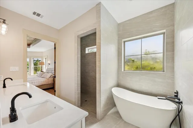 a bathroom with a bathtub and a sink