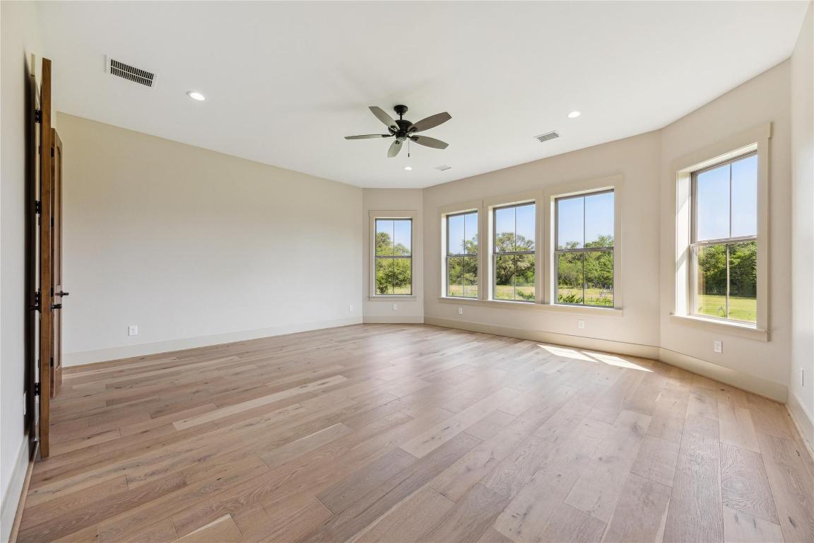 2130 Hartfield Road Round Top, TX 78954 - Photo 23 of 39 a view of room with window ceiling fan and hardwood floor