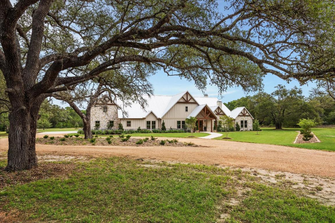 2130 Hartfield Road Round Top, TX 78954 - Photo 29 of 39 a front view of a house with a yard and large trees