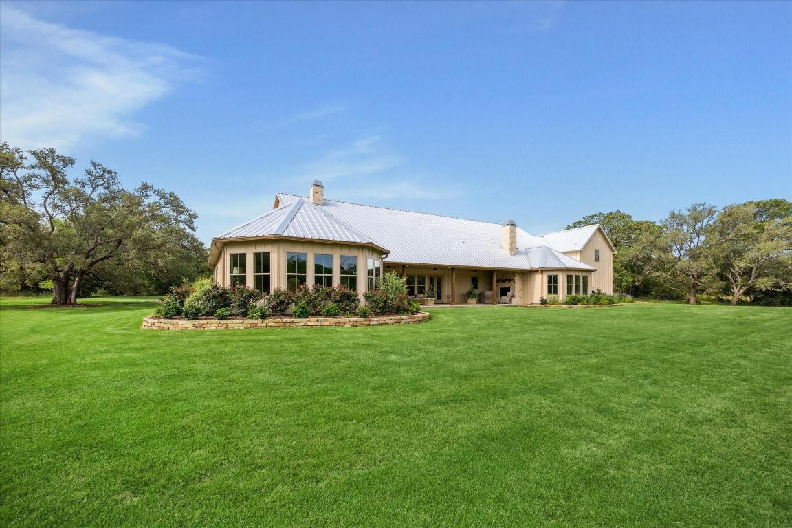 2130 Hartfield Road Round Top, TX 78954 - Photo 32 of 39 a front view of a house with a garden