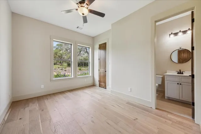 a view of a room with a sink wooden floor and windows