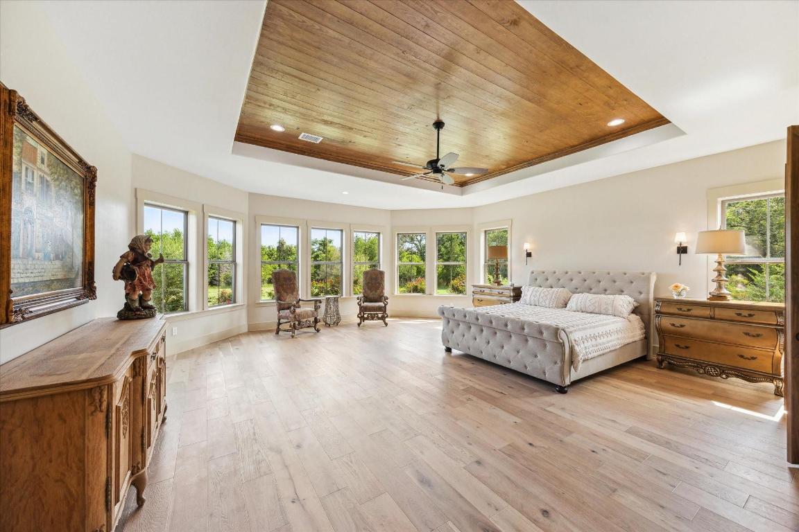 2130 Hartfield Road Round Top, TX 78954 - Photo 4 of 39 a spacious bedroom with a large bed and a large window