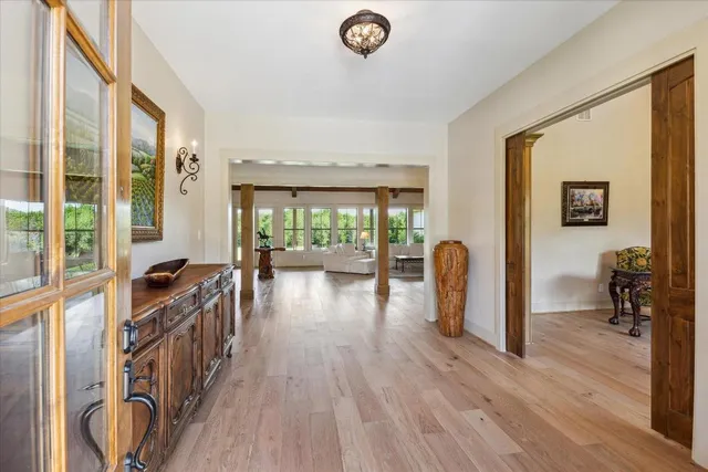 a view of a livingroom with furniture hardwood floor and a large window