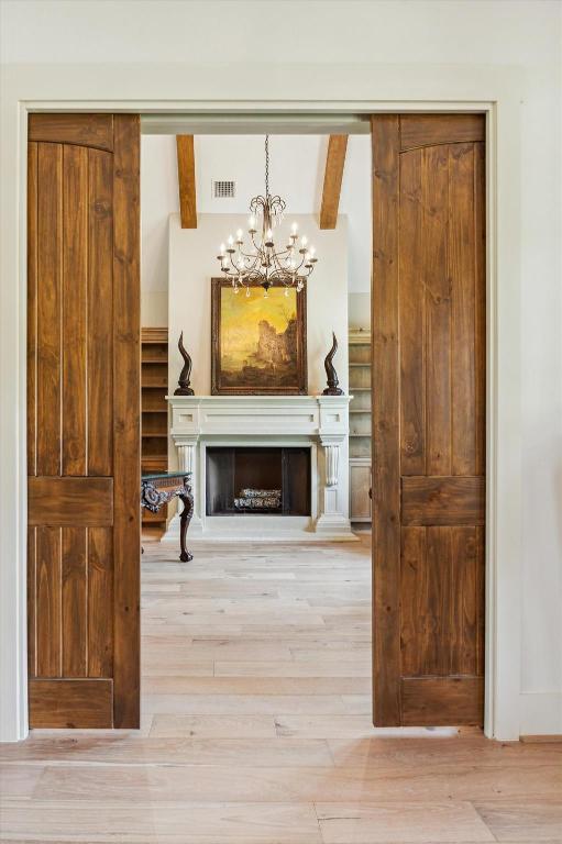 2130 Hartfield Road Round Top, TX 78954 - Photo 7 of 39 a view of a livingroom with wooden floor and a fireplace