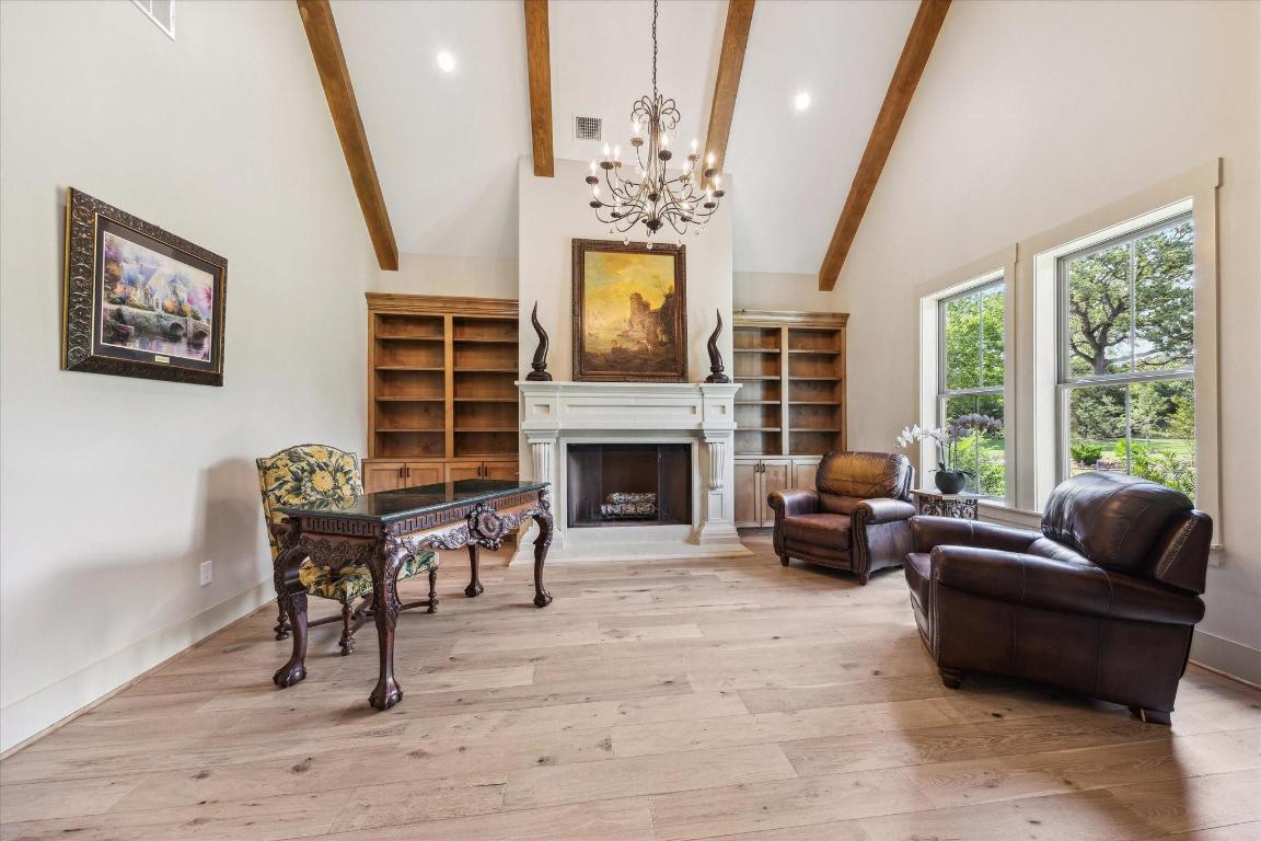 2130 Hartfield Road Round Top, TX 78954 - Photo 8 of 39 a living room with furniture a fireplace and a chandelier