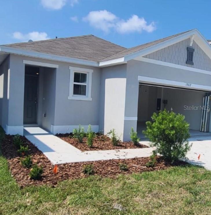 17017 Oval Rum Drive Wimauma, FL 33598 - Photo 1 of 1 a backyard of a house with table and chairs